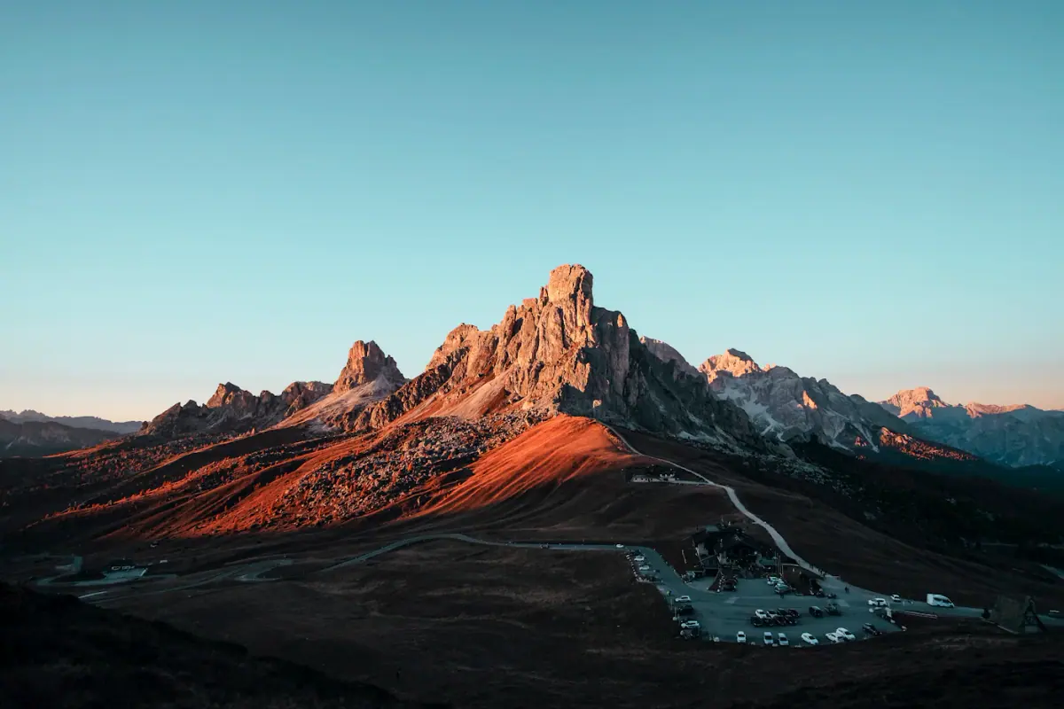 A tall mountain peak glowing at sunset
